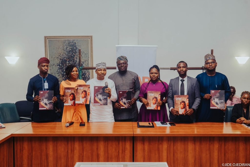 A picture with the report launched in Abuja.